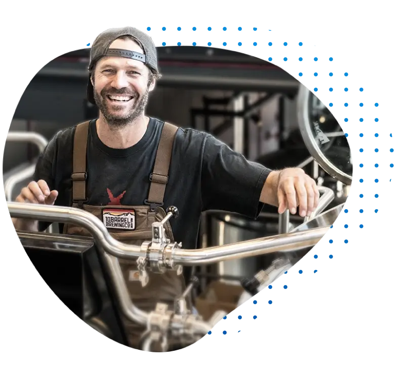 Brewery owner and small business owner smiling in his shop